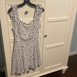 Black flowers  on white dress. Fluttering straps, backless, and tied with a bow